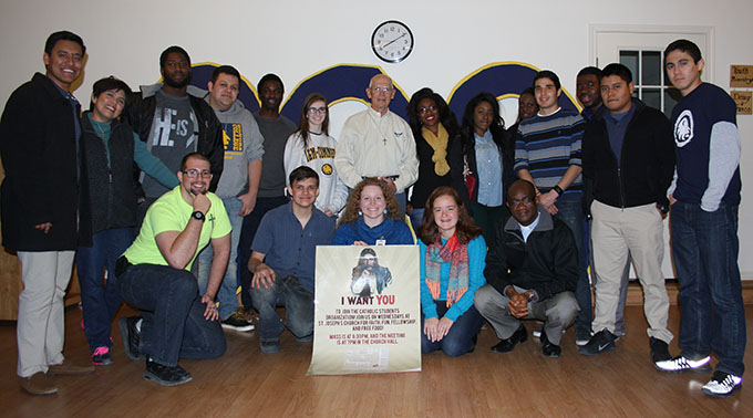 Father Marcus Chidozie (front row, far right), the pastoral administrator of St. Joseph Catholic Church in Commerce, Texas, and Deacon Joe Webber (back row, center), adviser to the parish’s Catholic Student Organization, pose with group members from Texas A&M-Commerce during the CSO meeting on Feb. 26. (CATHY HARASTA/The Texas Catholic)