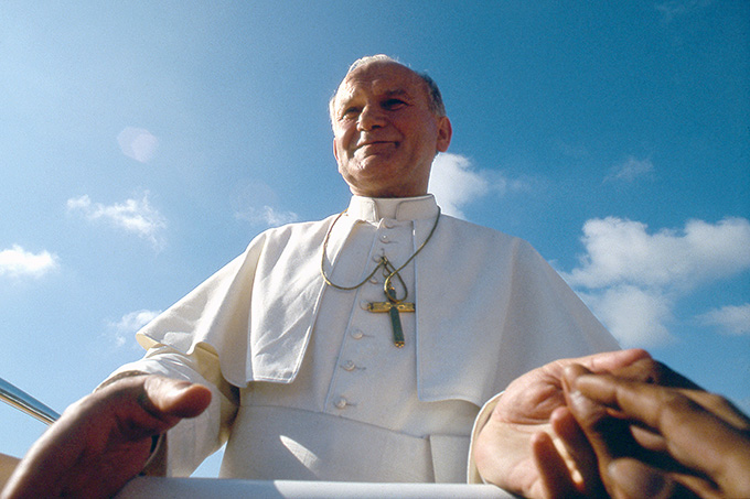 People reach out to Pope John Paul II during his 1981 visit to the Philippines. His 104 trips outside Italy made him by far the most widely traveled pope in history. (CNS photo/Catholic Press Photo)