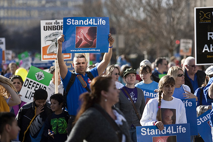 Flavio Lizcano (center, in blue) marches with his sons in January. Thousands of people participated in the 41st Dallas March for Life and Rally on the anniversary of Roe v. Wade. 