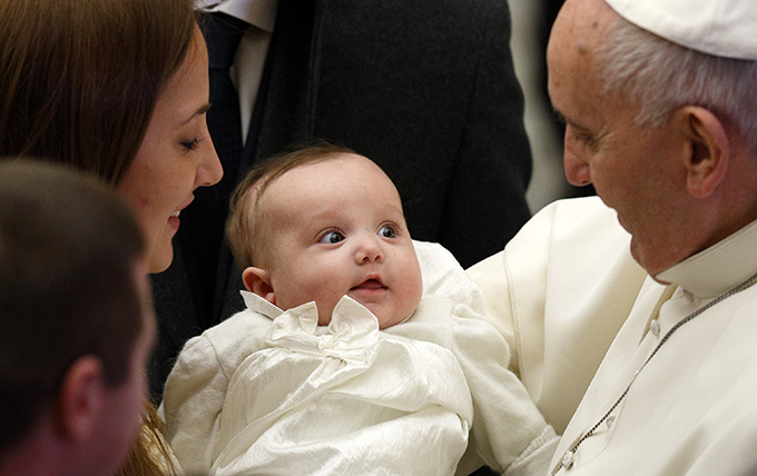 Pope Francis greets a baby during his general audience in Paul VI hall at the Vatican Jan. 7. (CNS photo/Paul Haring) 