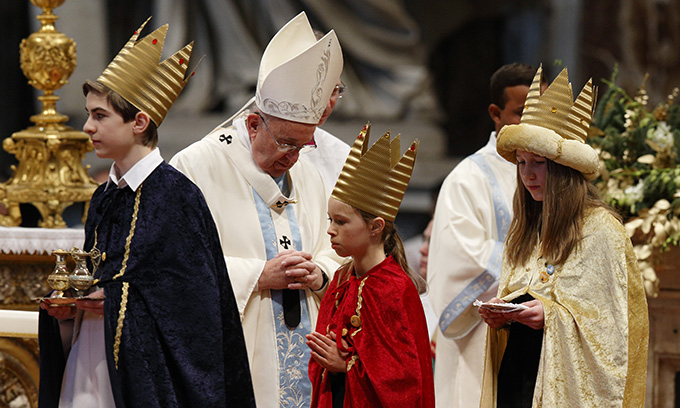 Children representing the Three Kings carry offertory gifts after presenting them to Pope Francis during Mass marking the feast of Mary, Mother of God, in St. Peter's Basilica at the Vatican Jan. 1. (CNS photo/Paul Haring) 