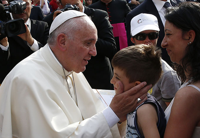 Pope Francis greets a boy during a gathering with young people in Piazza Vittorio in Turin, Italy, June 21. (CNS photo/Paul Haring) 