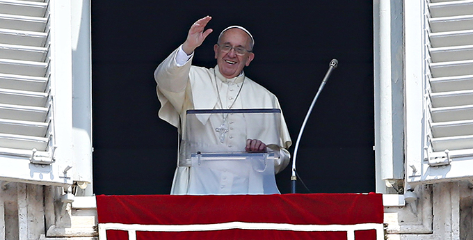 Pope Francis waves as he leads the Angelus from the window of his studio overlooking St. Peter's Square at the Vatican Aug. 9. (CNS photo/Tony Gentile, Reuters)