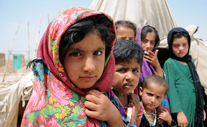 Afghan children are seen in late May at a temporary shelter in an internally displaced persons camp on the outskirts of Balkh province, Afghanistan. To promote a reflection on the need for a "conversion of mind and heart" open to the needs of others, Pope Francis has chosen "Overcome indifference and win peace" as the theme for the church's celebration of the World Day of Peace 2016. (CNS photo/Sayed Mustafa, EPA)