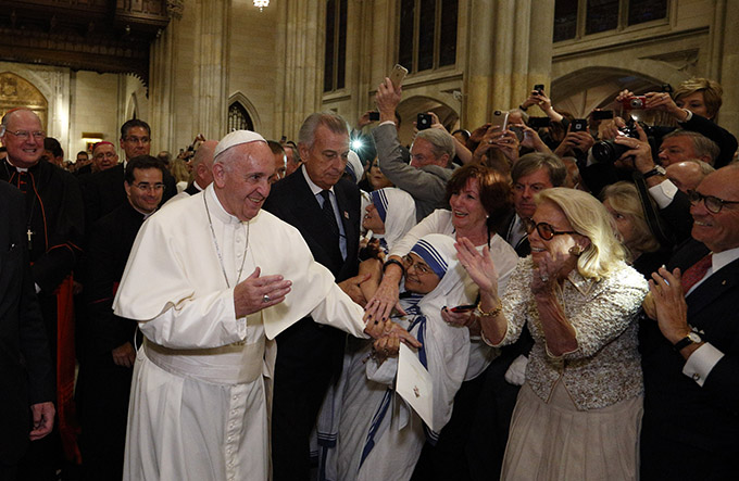 Pope Francis greets people as he arrives to celebrate vespers with priests, men and women religious in St. Patrick's Cathedral in New York Sept. 24. (CNS photo/Paul Haring) 