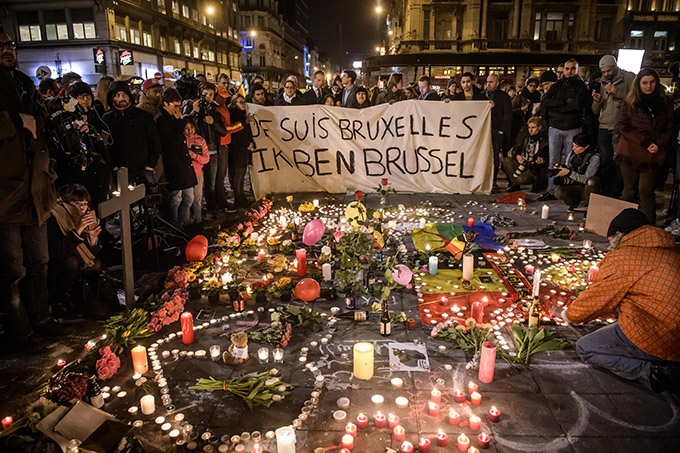 People gather at Place de la Bourse March 22 to pay tribute to the victims of the bomb attacks in Brussels. Three nearly simultaneous attacks that day claimed the lives of dozens and injured more than 200. (CNS photo/Christophe Petit Tesson, EPA) 