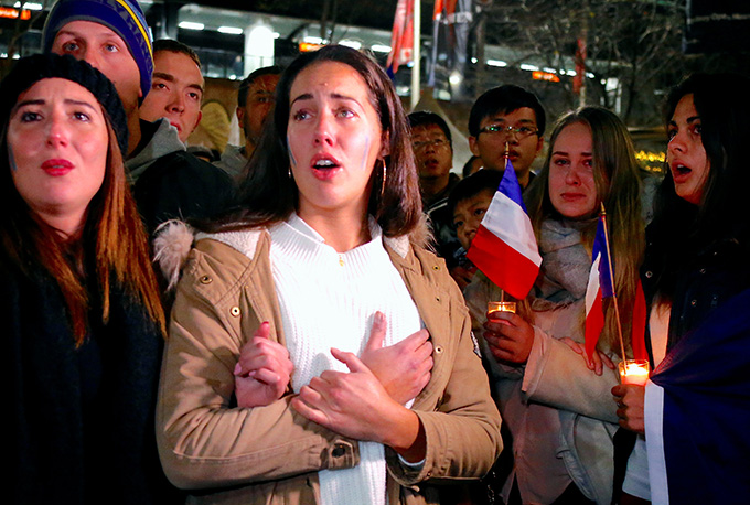 Members of the Australian French community mourn during a July 15 candlelight vigil in central Sydney to remember the victims of the Bastille Day truck attack in Nice, France. A truck loaded with weapons and hand grenades drove onto a sidewalk in Nice for more than a mile July 14, killing more than 80 people. (CNS photo/David Gray, Reuters)
