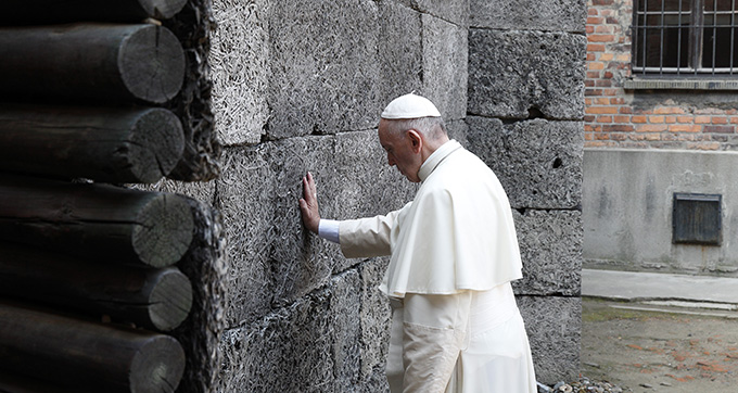 Pope Francis touches the death wall at the Auschwitz Nazi death camp in Oswiecim, Poland, July 29. (CNS photo/Paul Haring) 