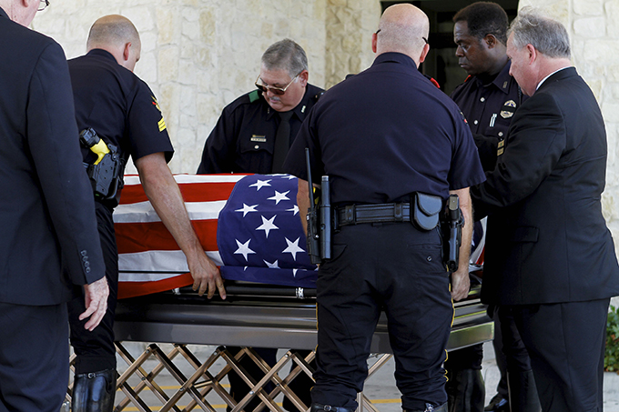 The body of Dallas Police Department Sgt. Michael Smith arrives at Mary Immaculate Catholic Church in Farmers Branch on July 12. Sgt. Smith was one of five officers killed by a sniper on July 7. (KEVIN BARTRAM/Special Contributor)