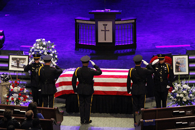 Dallas police officers switch guard duty with a salute near the casket of Senior Cpl. Lorne Ahrens during his funeral service o July 13 at Prestonwood Baptist Church in Plano. (Ben Torres/Special Contributor)