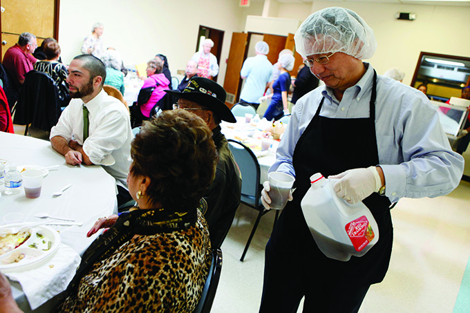 Deacon George Chou of Sacred Heart of Jesus Chinese parish, serves elderly folks during a Thanksgiving meal for the elderly at the Marrilac Center in November 2015. (Ben Torres/Special Contributor)