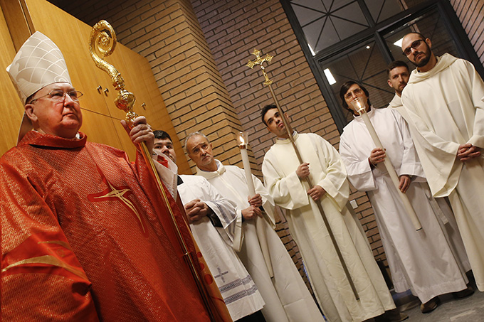 Cardinal Kevin J. Farrell, prefect of the Dicastery for Laity, Family and Life, is pictured near altar servers as he celebrates a Mass at which he took possession of his titular church, St. Julian the Martyr, in Rome Jan. 29. (CNS photo/Giampiero Sposito)