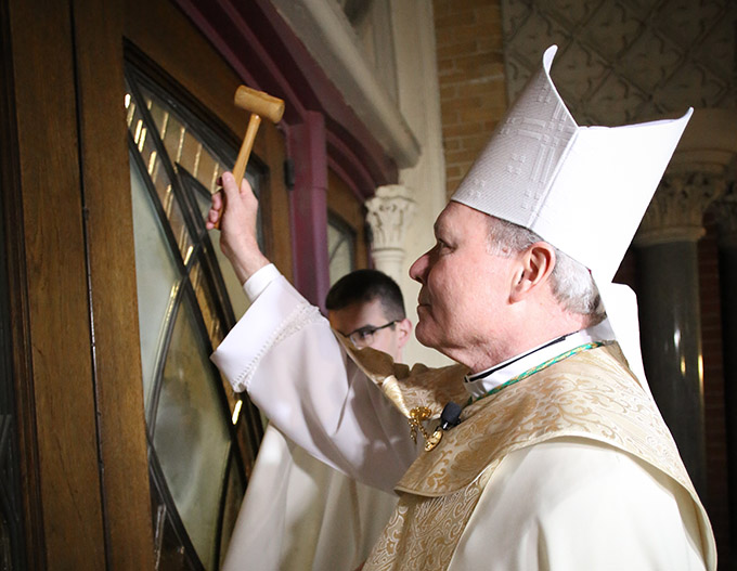 In a symbolic gesture prior to solemn vespers, Bishop Edward J. Burns knocks on the door of the Cathedral Shrine of the Virgin of Guadalupe on Feb. 8 as he prepares to become the eighth bishop of the Catholic Diocese of Dallas. (KEVIN BARTRAM/Special Contributor)