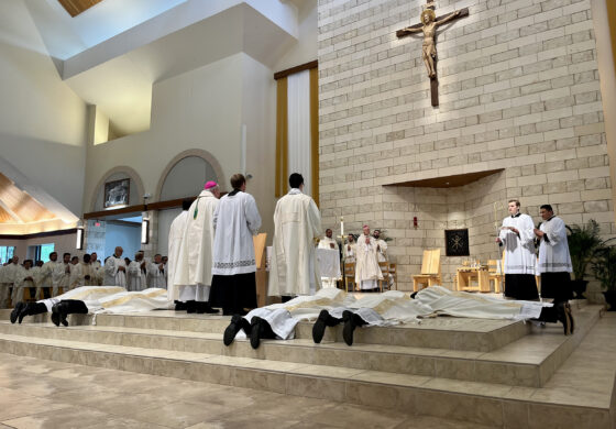 Bishop Burns ordains eight men to the priesthood